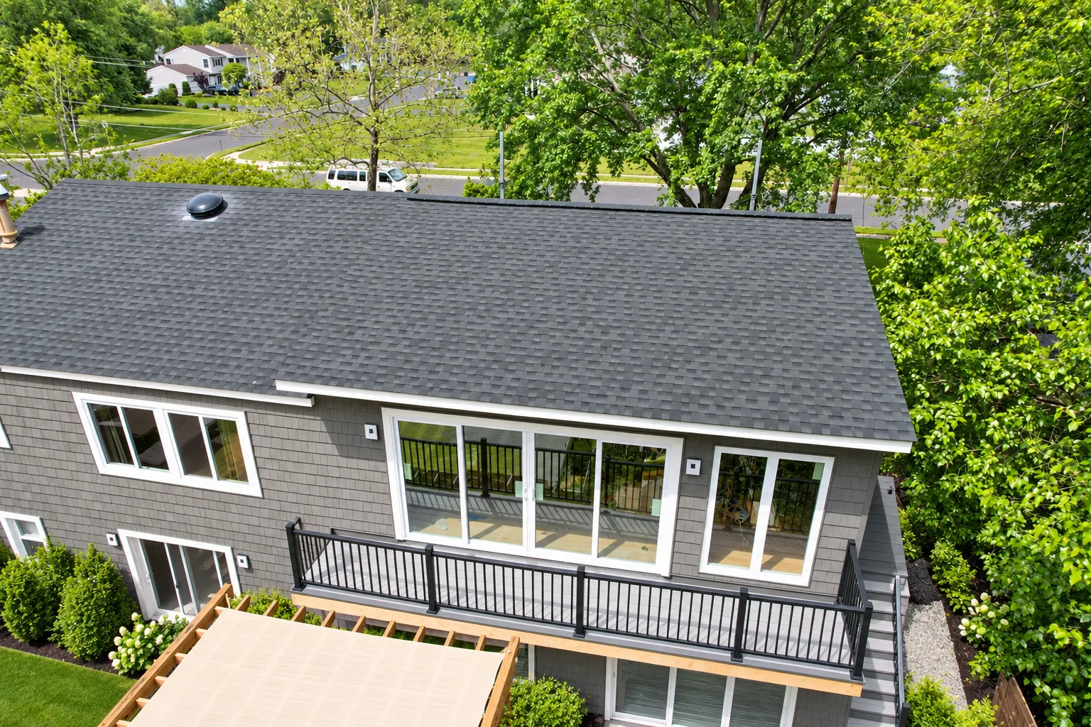Rear elevation from above — sliding doors open to the primary suite balcony